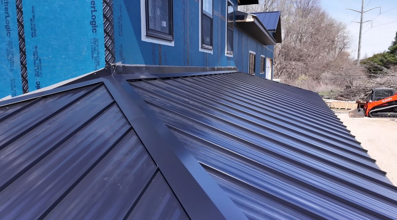 Professional roofing contractor installing quality metal roof in Chelsea, MA